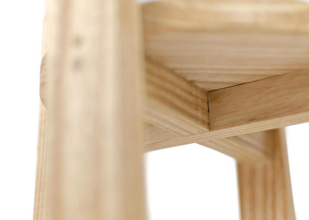 Close-up of a leg joining the round top, with two dowel holes in the leg.