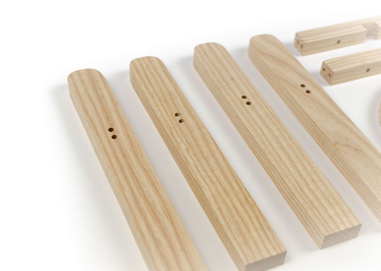 Close-up of the four wooden legs with their drilled dowel holes.