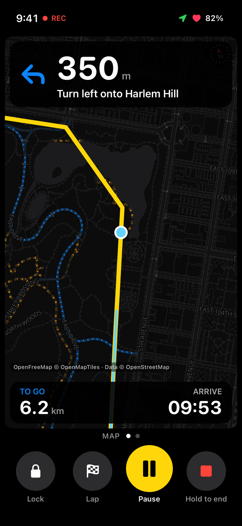The Map page drawn with MapLibre: a dark map of Central Park with cycleways in blue and unpaved paths dashed in amber, the route in yellow and a blue position dot, with the next turn at the top and the map's credit at the bottom.
