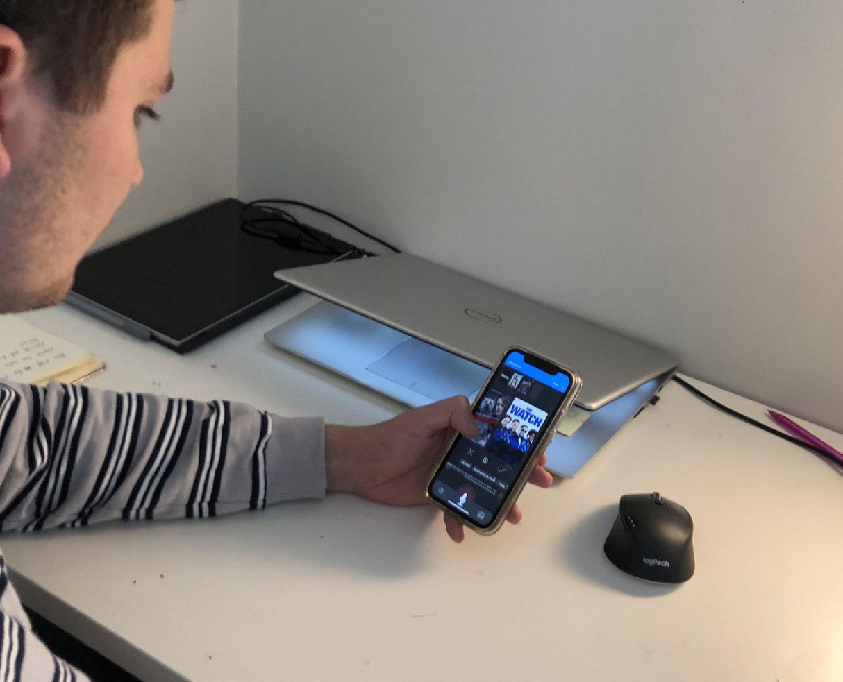 A tester at a desk trying the Andy app on a phone.
